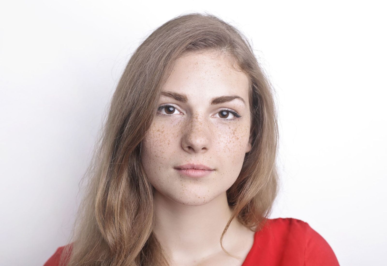 The same portrait with the natural preset: lightly smoothed, slightly brighter skin, freckles still visible